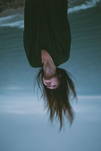 Low section of young woman in water