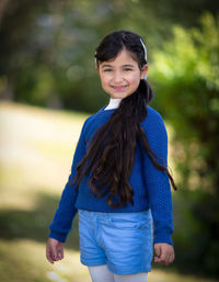 Portrait of smiling woman standing outdoors