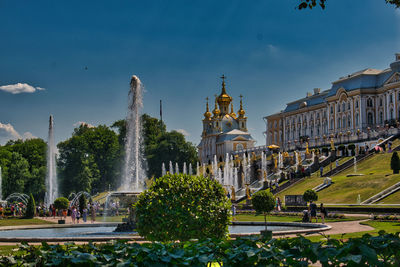 Fountain in city against sky