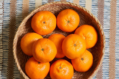 High angle view of orange fruits in basket