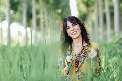 Portrait of smiling young woman on field