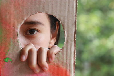 Close-up portrait of a boy peeking