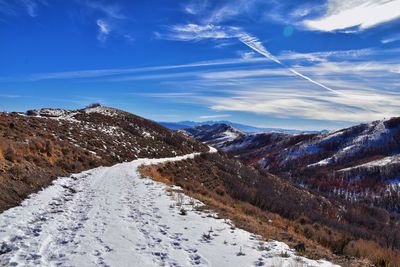 Scenic view of snowcapped mountains against sky