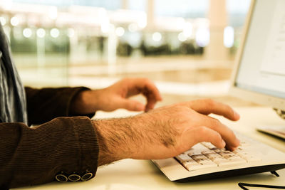 Close-up of man using laptop