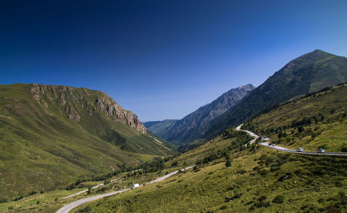 Scenic view of mountains against clear blue sky