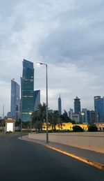 View of city street and buildings against sky