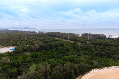 Scenic view of trees and sea against sky