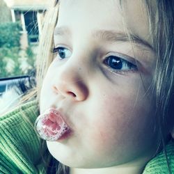 Close-up of cute girl blowing bubble