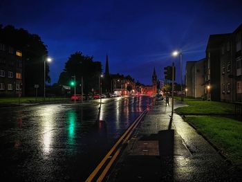 Illuminated street lights in city at night