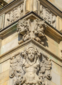 Low angle view of statues on old building