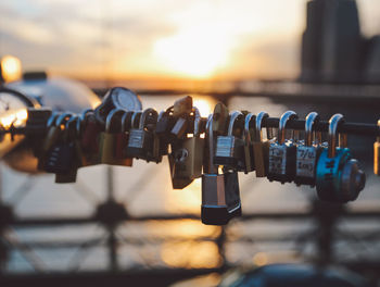 Close-up of love locks hanging on railing at brooklyn bridge