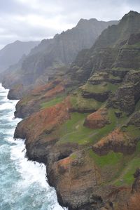 Scenic view of sea and mountains against sky