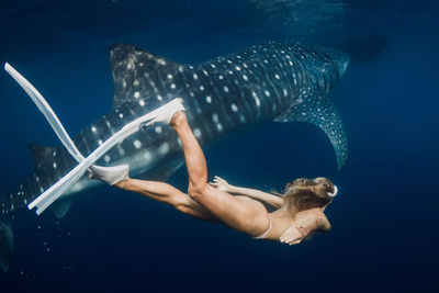 Low section of woman swimming in sea