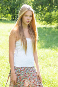 Portrait of beautiful teenage girl standing on field