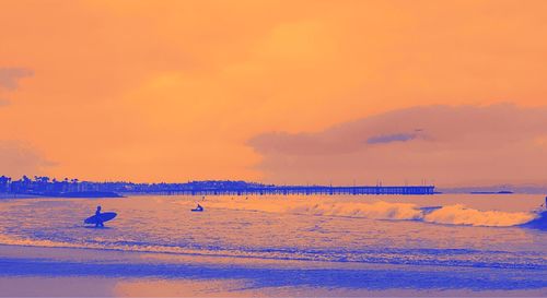 Scenic view of sea against orange sky during sunset