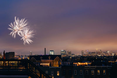 Firework display over city at night