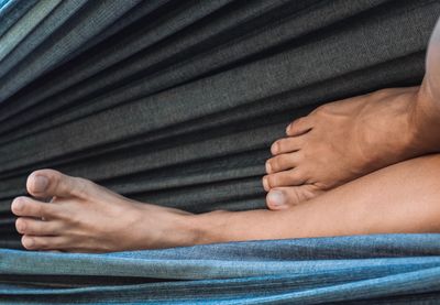 Low section of woman lying on fabric