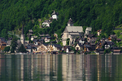 Houses by lake and buildings in town