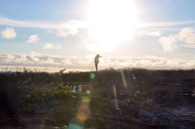 Woman standing with arms outstretched in landscape