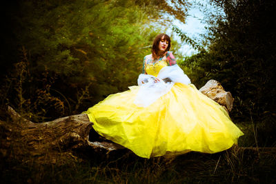 Rear view of woman standing in forest