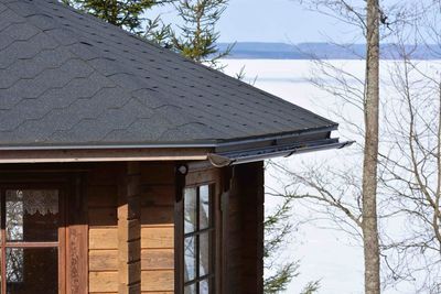 Snow covered roof against sky