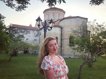 Portrait of woman against building