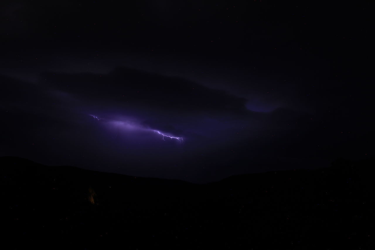 night, lightning, beauty in nature, power in nature, sky, cloud, storm, thunderstorm, scenics - nature, environment, no people, darkness, nature, mountain, thunder, silhouette, dark, dramatic sky, illuminated, outdoors, warning sign, awe, star, light - natural phenomenon