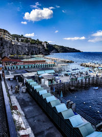 High angle view of beach by buildings against sky