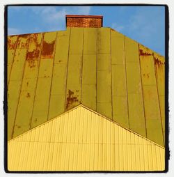 Low angle view of built structure against blue sky