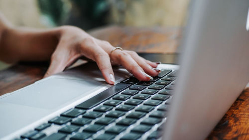 Midsection of  woman using laptop