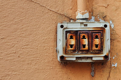 Close-up of telephone booth on wall