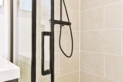 Close-up of shower head in bathroom