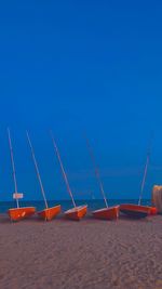 Scenic view of beach against clear blue sky