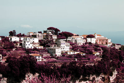 High angle view of houses in town against clear sky