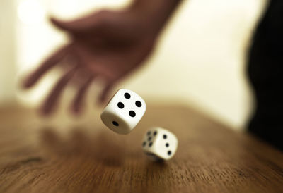 Close-up of person playing with ball on table