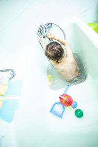 High angle view of boy playing in bathroom at home