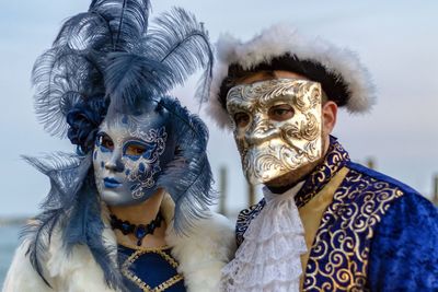 Close-up of man and woman wearing venetian mask 