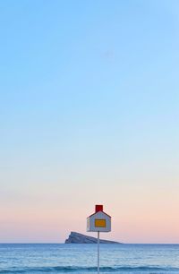 Scenic view of sea against clear sky during sunset