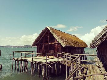 Built structure by sea against sky