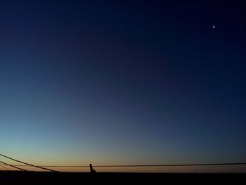 Low angle view of silhouette landscape against clear sky