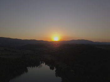 Scenic view of silhouette mountains against sky during sunset