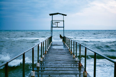 Pier amidst sea against sky