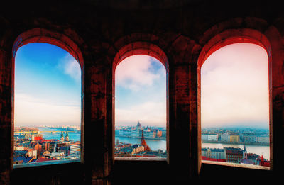 Buildings and sea seen through window