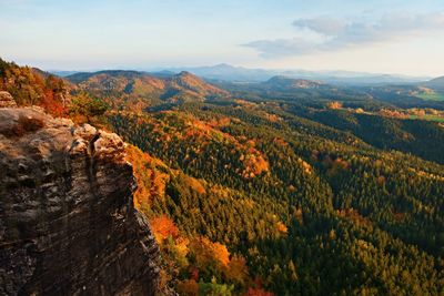 Autumn sunset view over colorful rocks to fall valley of bohemian switzerland.