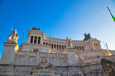 Low angle view of statue against blue sky