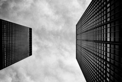 Low angle view of modern building against cloudy sky