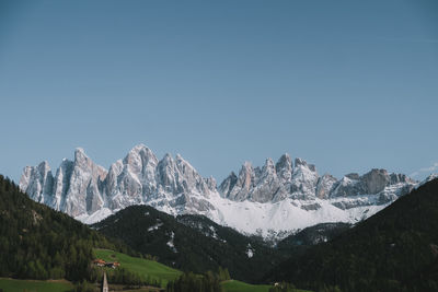 Scenic view of snowcapped mountains against clear sky