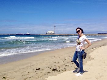Young woman by the ocean in matosinhos, porto, portugal. sandy beach. 