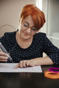 Senior woman drawing with 3d pen