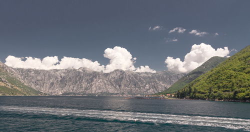 Scenic view of sea and mountains against sky